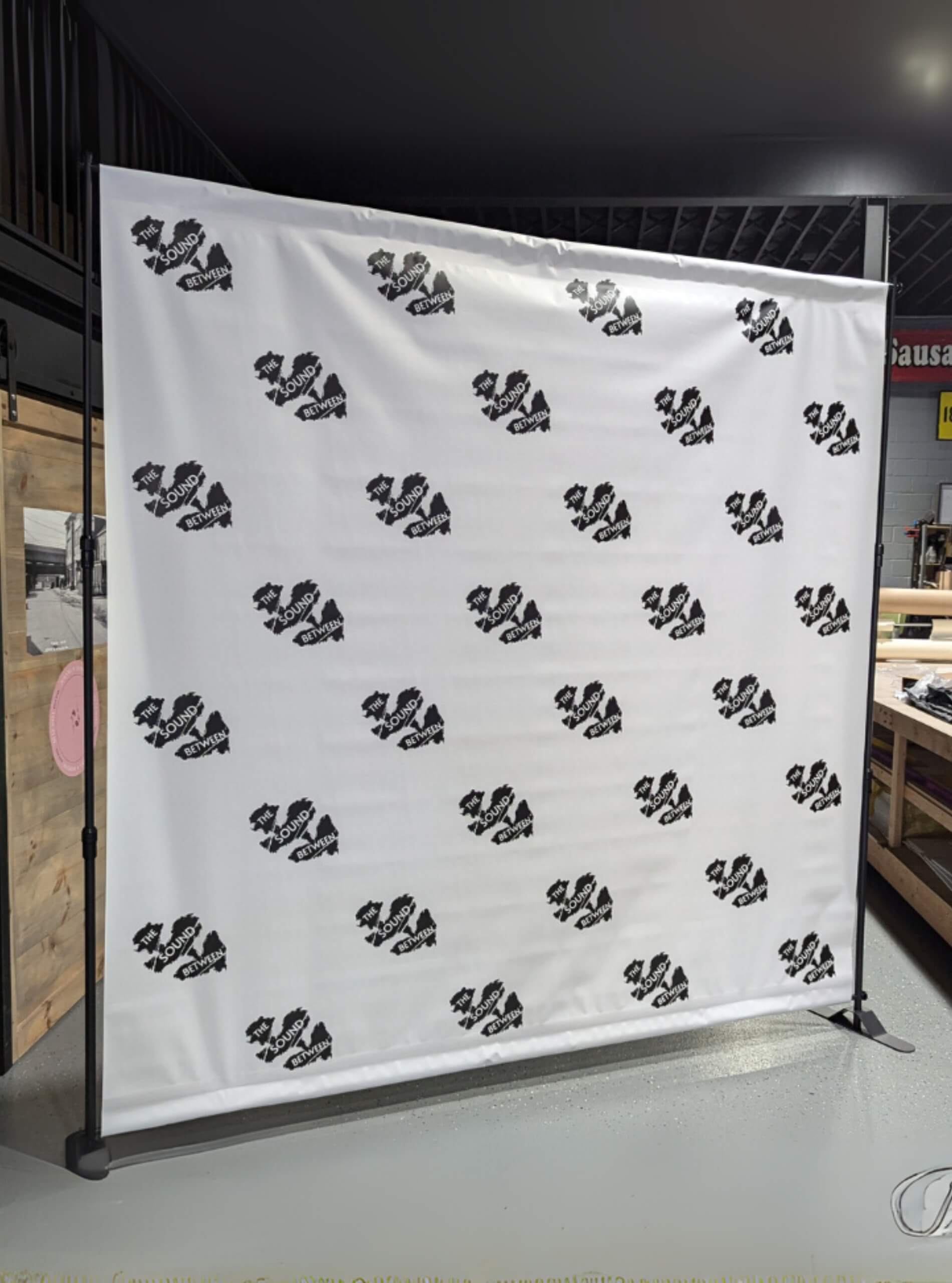 step and repeat backdrop white brand logo display